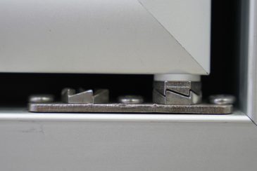 Bottom hinge hardware mounted on a glass door