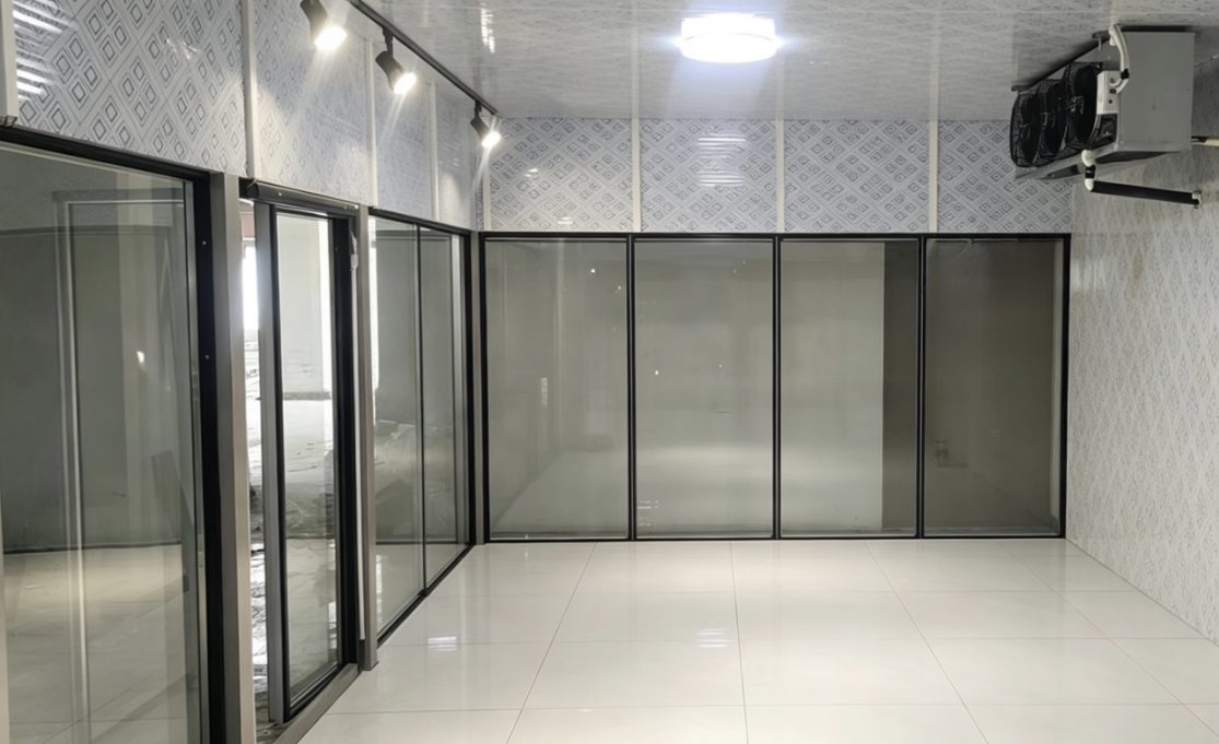 Walk-in cold room interior viewed through glass